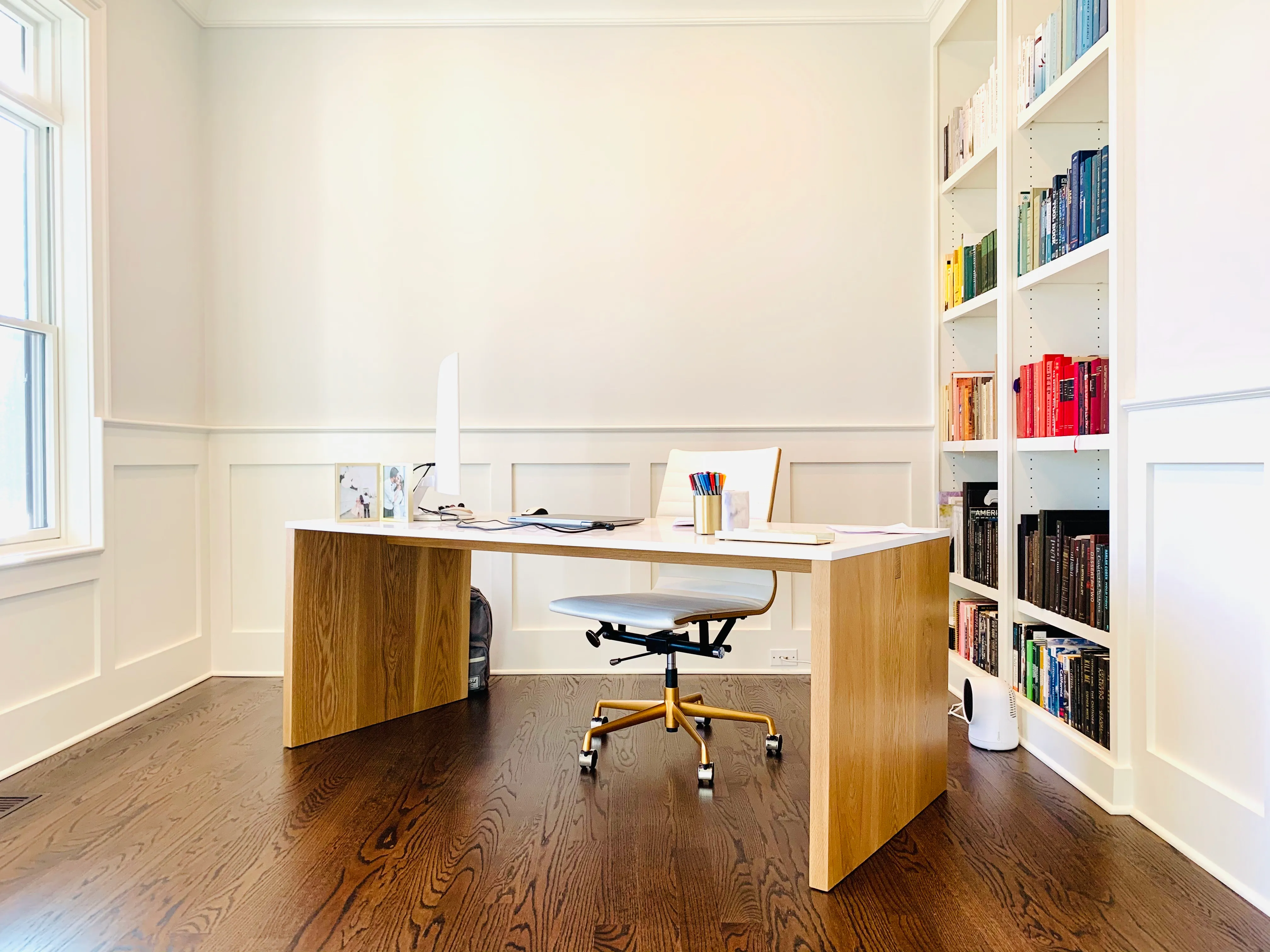 The Planes and Beam Desk in a home office, white oak with a quartz top.